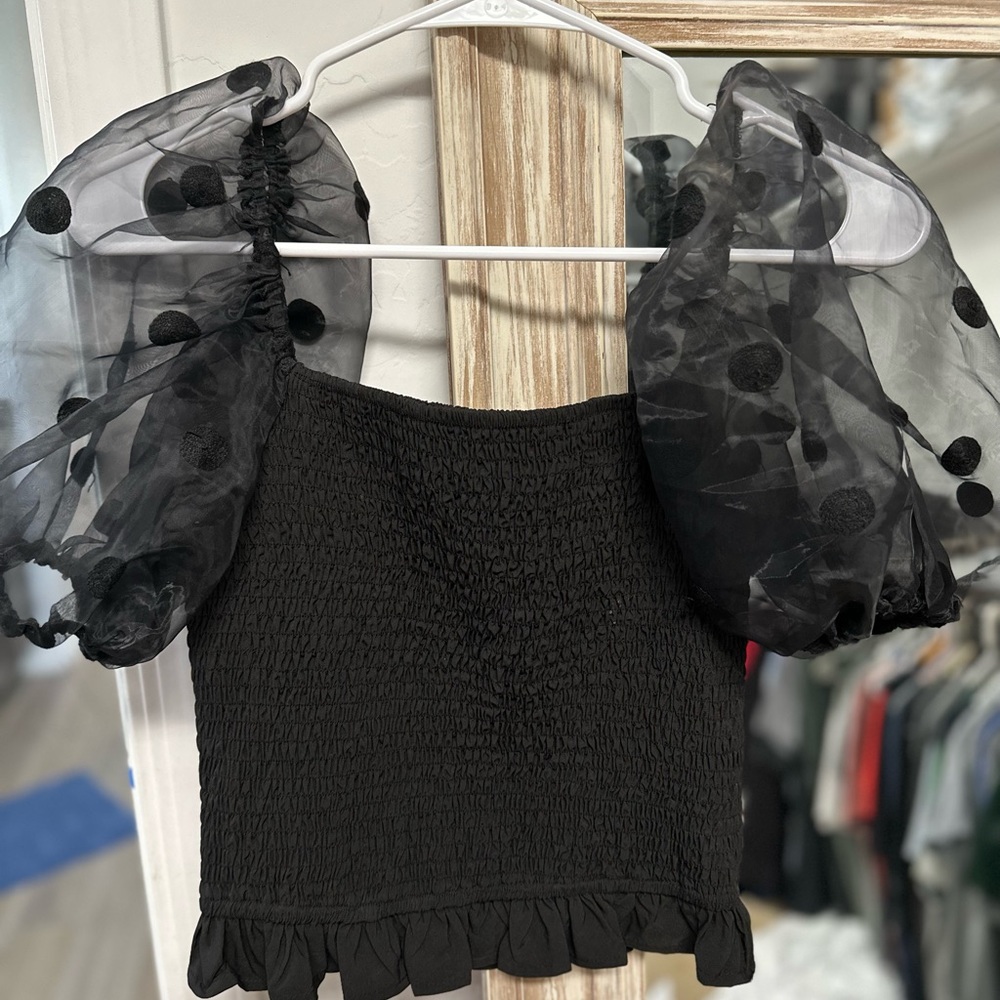 Black top with sheer polka dot shoulders